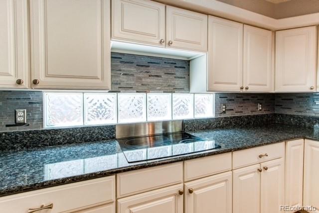 10144 Alexa Lane Highlands Ranch, CO 80130 - Photo 8 of 33 a kitchen with granite countertop white cabinets and a sink