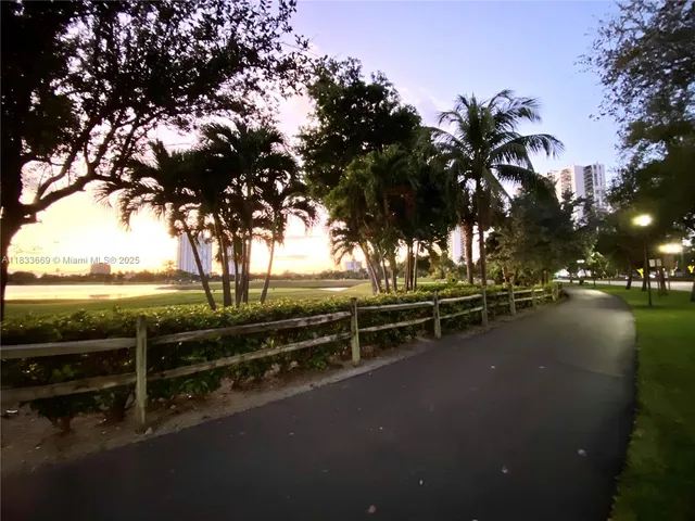 a view of a street with chairs