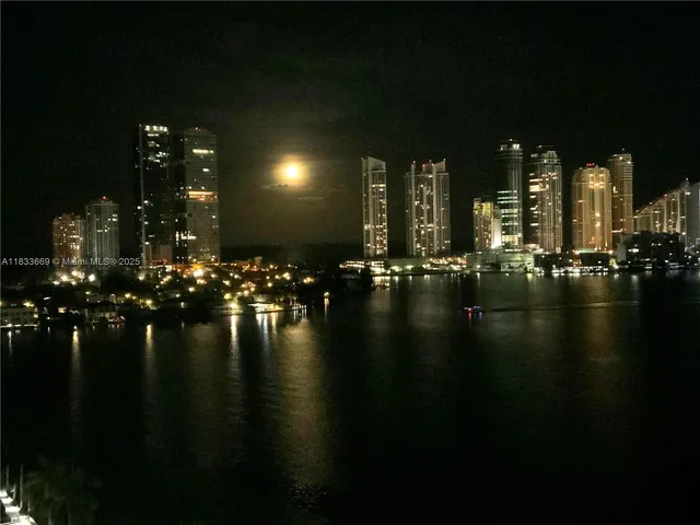 a bathroom with a tub a double vanity sink and a large mirror