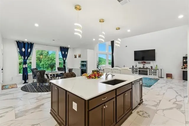 a kitchen with sink stove and refrigerator