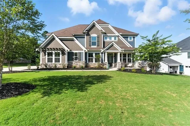 a front view of a house with a yard table and chairs