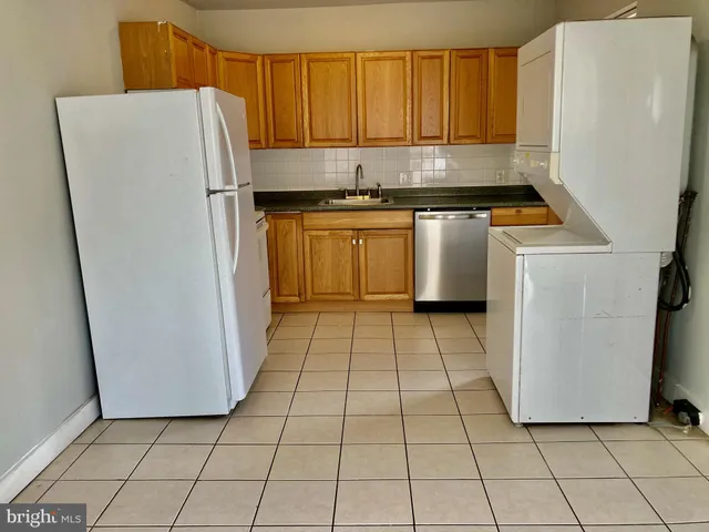 a kitchen with a refrigerator a stove a microwave and cabinets