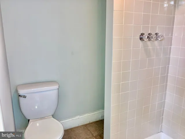 a white toilet sitting next to a bathroom sink