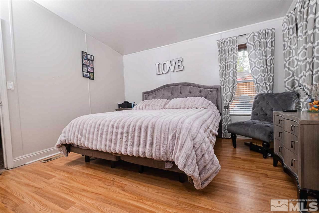 2745 Snapdragon Way Reno, NV 89512 - Photo 12 of 30 a bedroom with a bed and wooden floor