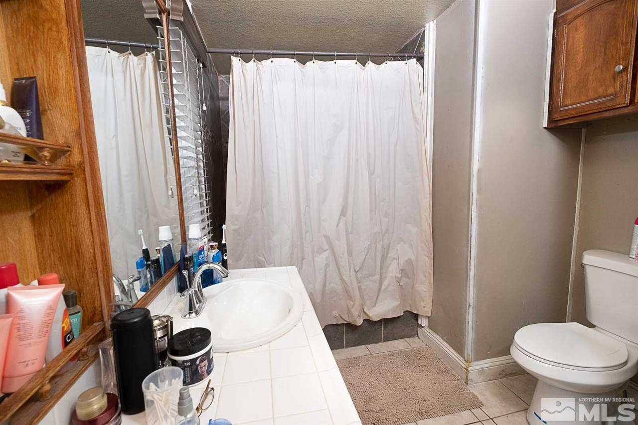 2745 Snapdragon Way Reno, NV 89512 - Photo 15 of 30 a bathroom with a sink toilet and shower