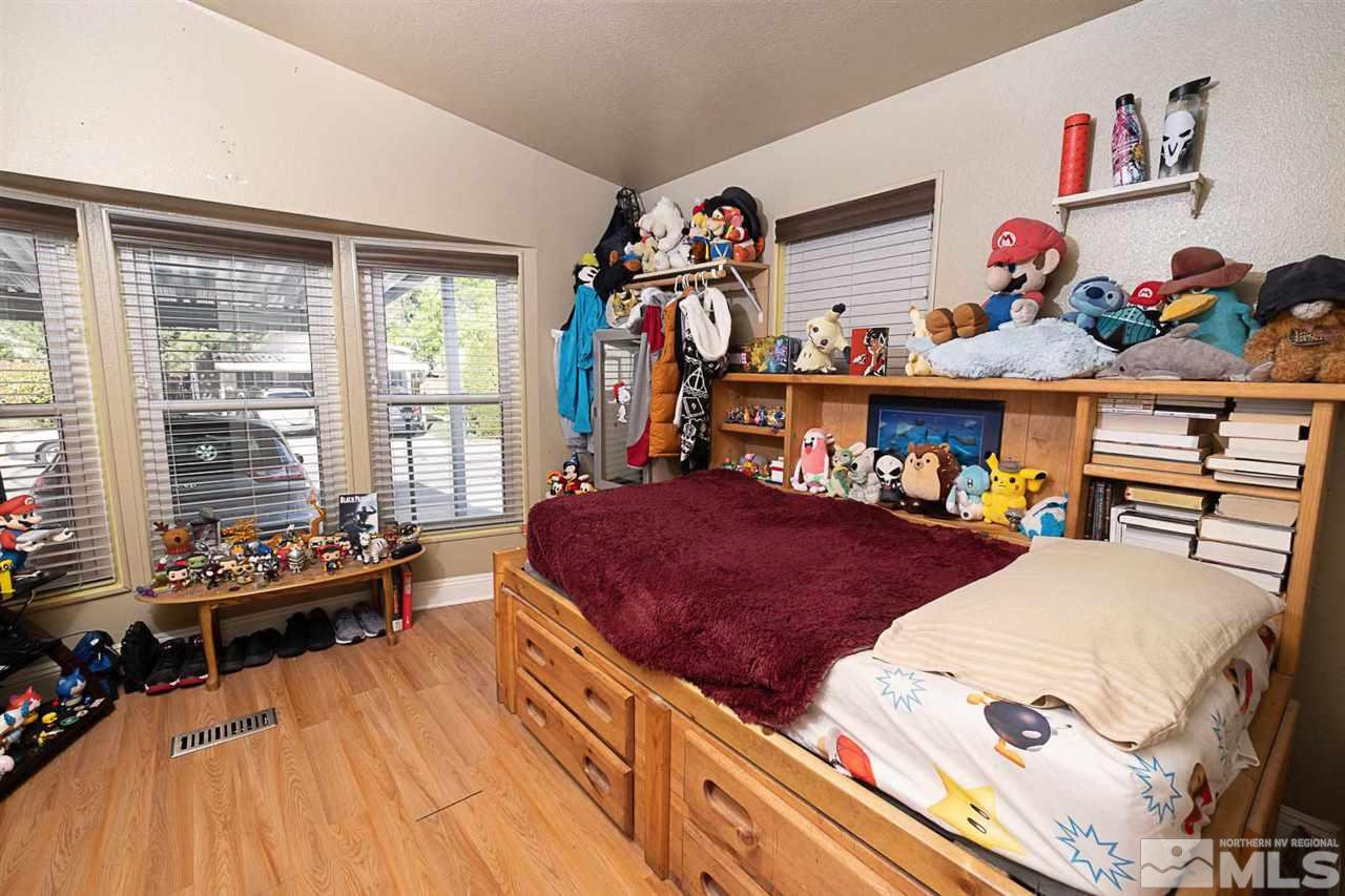 2745 Snapdragon Way Reno, NV 89512 - Photo 18 of 30 a bedroom with furniture and a large window