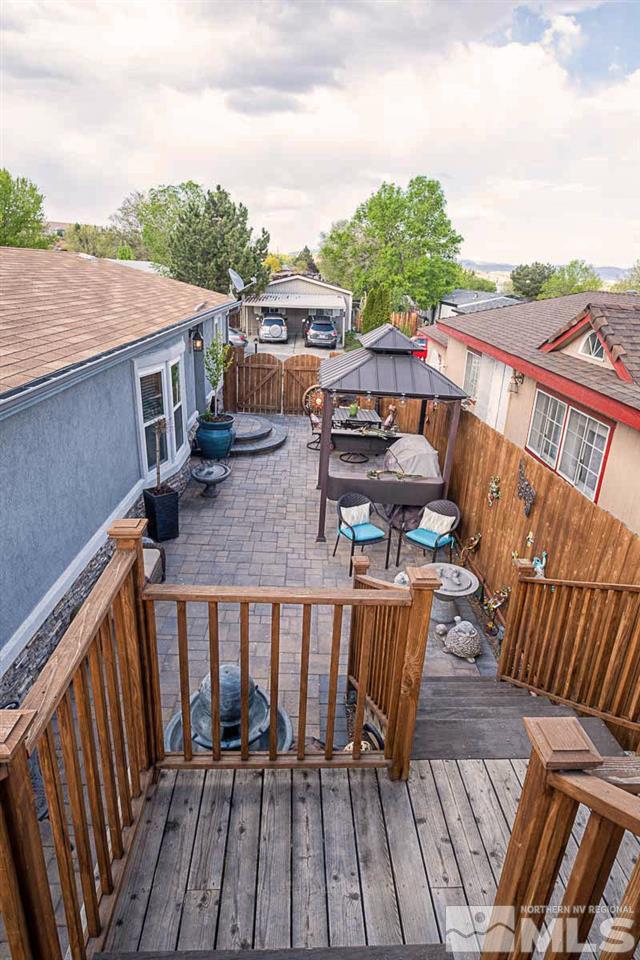 2745 Snapdragon Way Reno, NV 89512 - Photo 24 of 30 a balcony with wooden floor outdoor seating and barbeque oven
