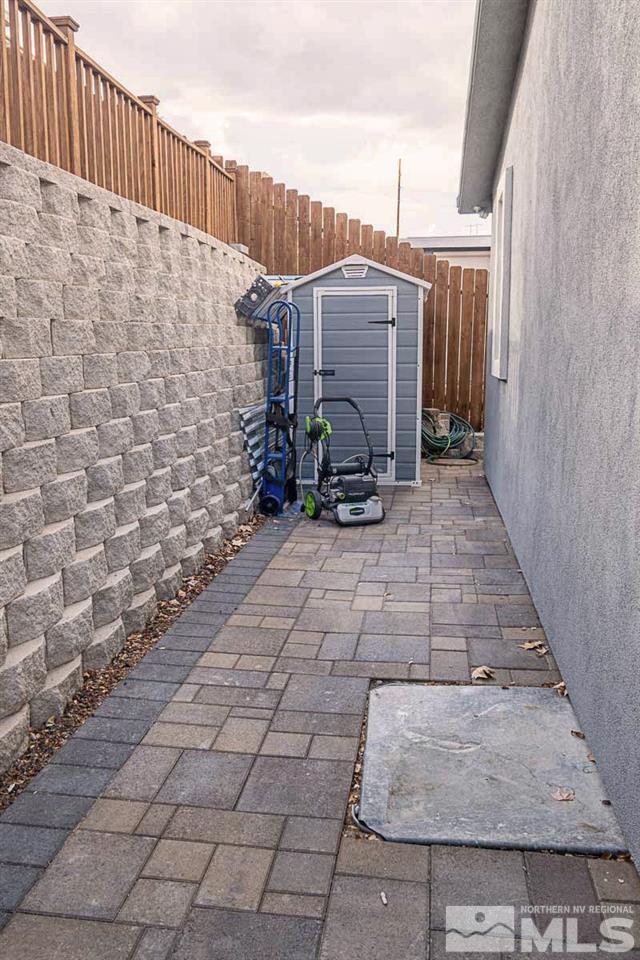 2745 Snapdragon Way Reno, NV 89512 - Photo 28 of 30 a backyard of a house with chairs and wooden fence