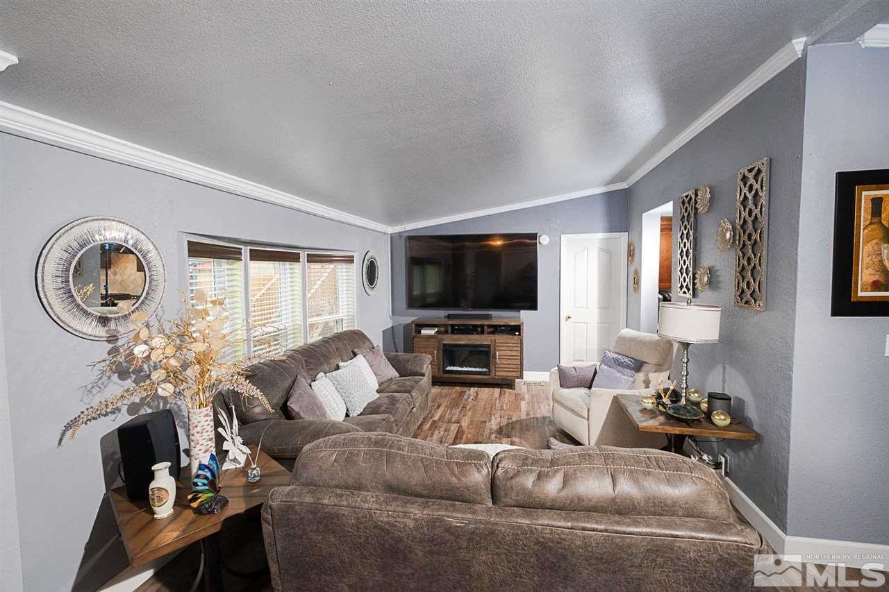 2745 Snapdragon Way Reno, NV 89512 - Photo 5 of 30 a living room with furniture a flat screen tv and a fireplace