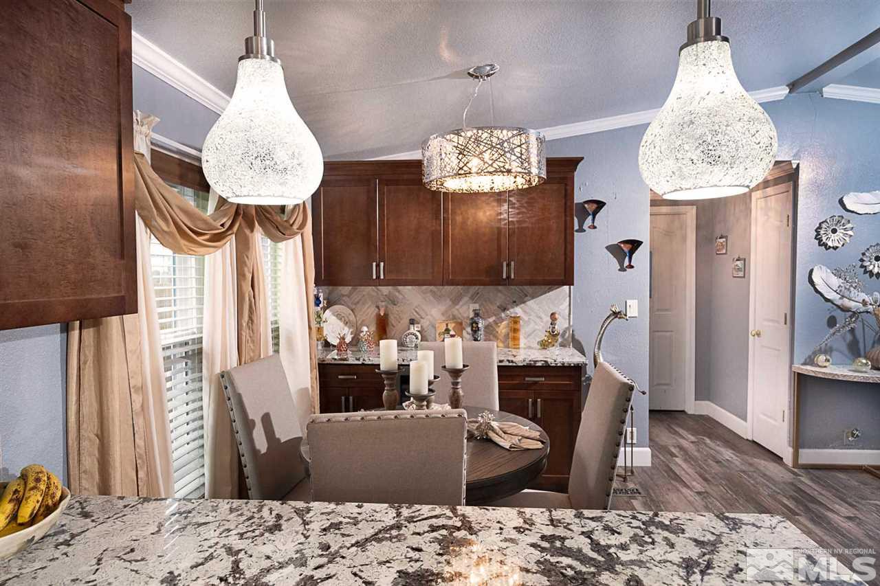 2745 Snapdragon Way Reno, NV 89512 - Photo 8 of 30 a dining room with furniture and a chandelier