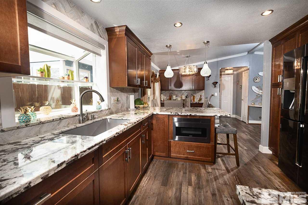 2745 Snapdragon Way Reno, NV 89512 - Photo 10 of 30 a kitchen with stainless steel appliances granite countertop a stove a sink and a refrigerator