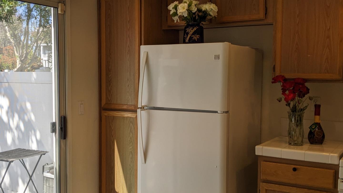 5691 Spry Common Fremont, CA 94538 - Photo 12 of 20 a white refrigerator freezer sitting in a kitchen