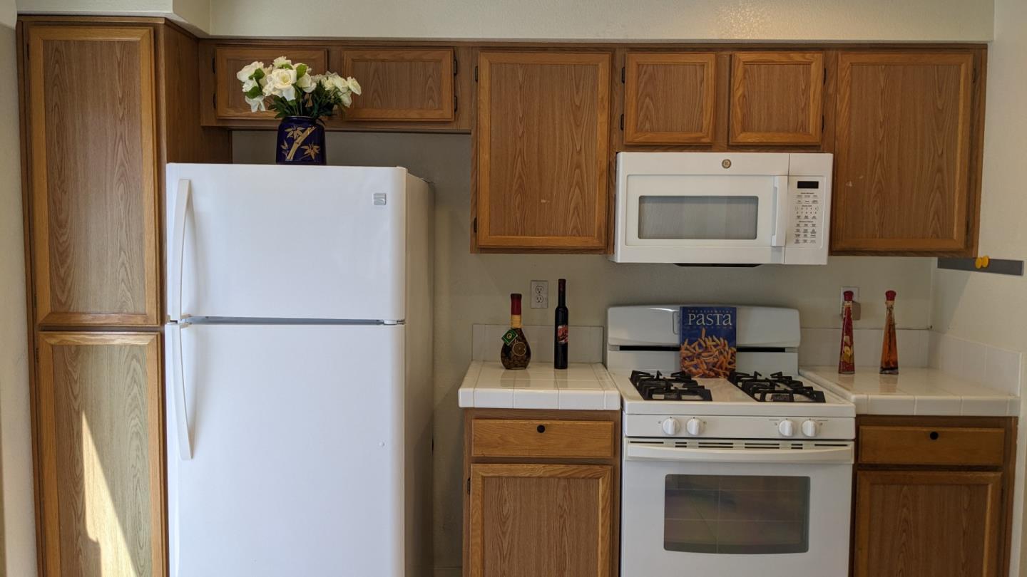 5691 Spry Common Fremont, CA 94538 - Photo 9 of 20 a kitchen with a refrigerator sink stove and microwave
