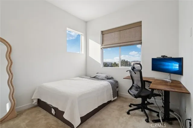 a bedroom with a bed and a desk