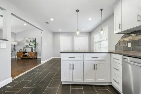 a kitchen with sink cabinets and living room view