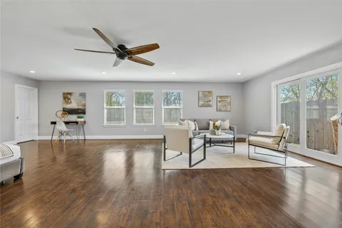a living room with furniture and a wooden floor