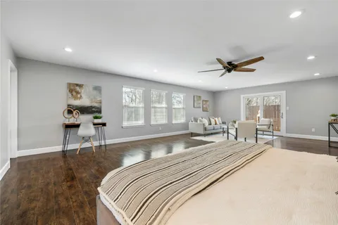 a spacious bedroom with a large bed and a large window