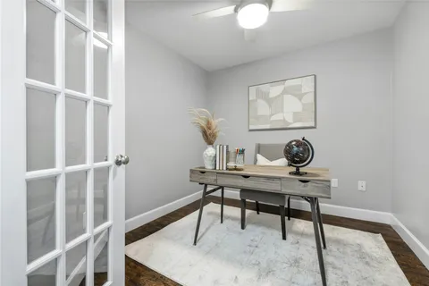 a view of a workspace room with wooden floor and chair