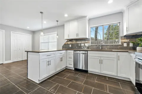 a kitchen with a sink window and cabinets