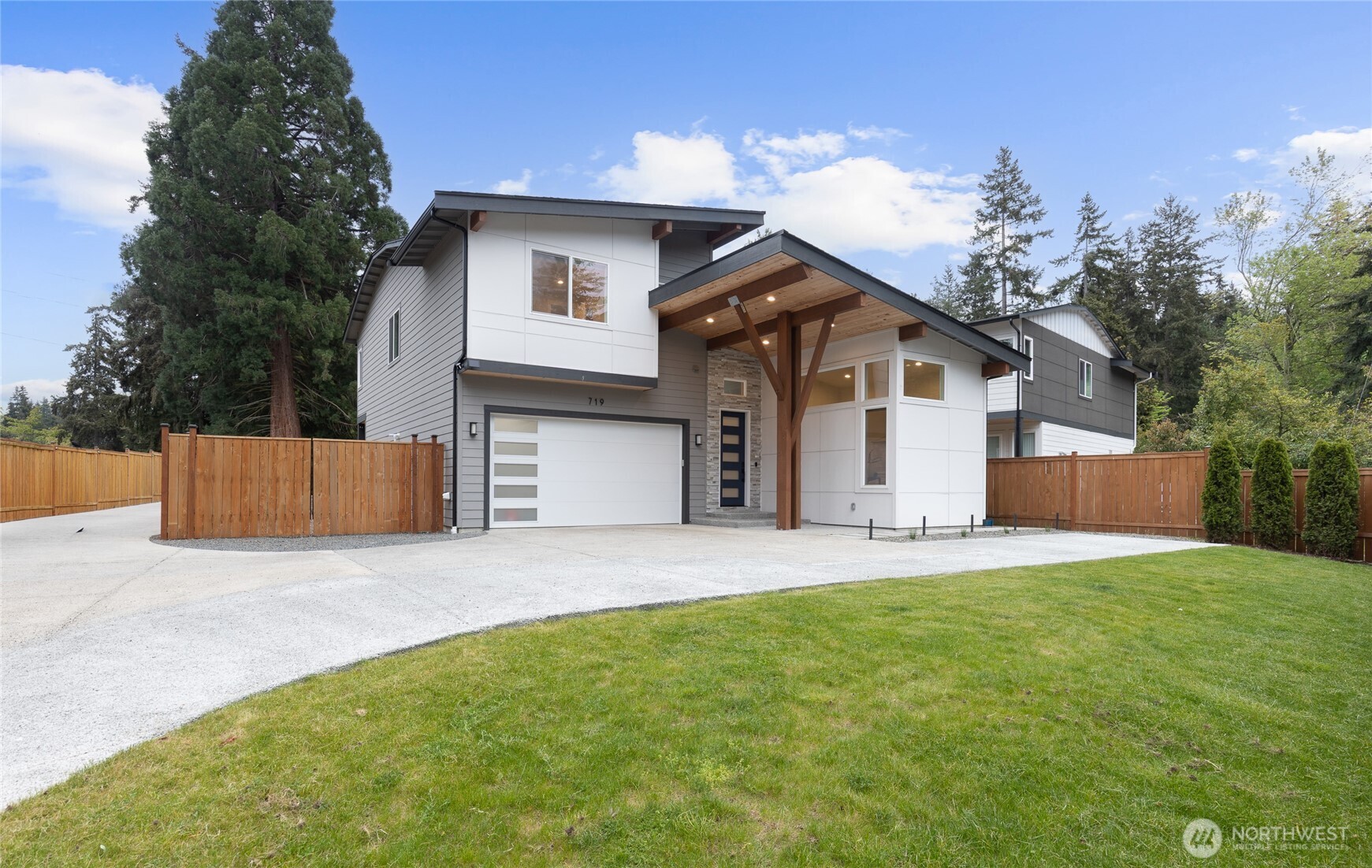 719 Edmonds Way Edmonds, WA 98020 - Photo 1 of 40 a front view of a house with a yard and garage