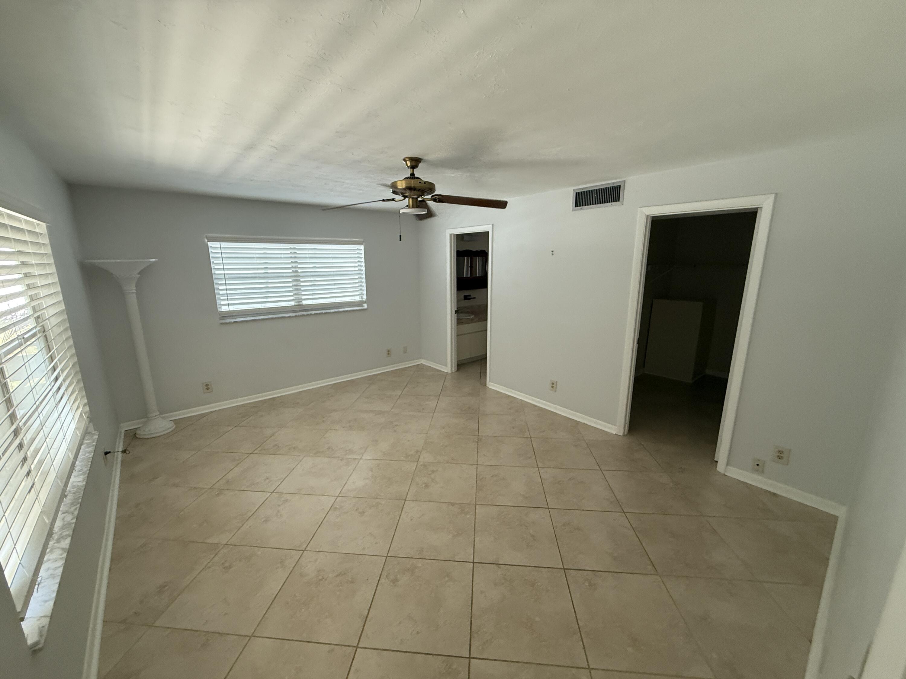 125 Mayfield Road, Unit B Lantana, FL 33462 - Photo 4 of 8 a view of an empty room with a window