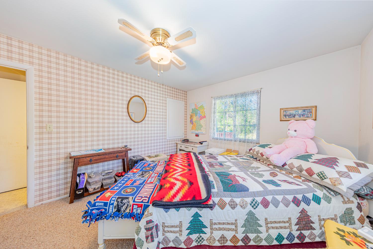 42585 Buckeye Road Oakhurst, CA 93644 - Photo 16 of 55 a bedroom with a bed and a chandelier