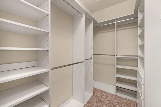 a view of walk in closet with empty racks