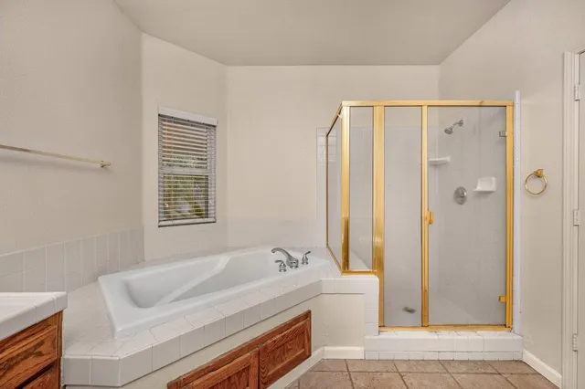 a bathroom with a tub sink and toilet