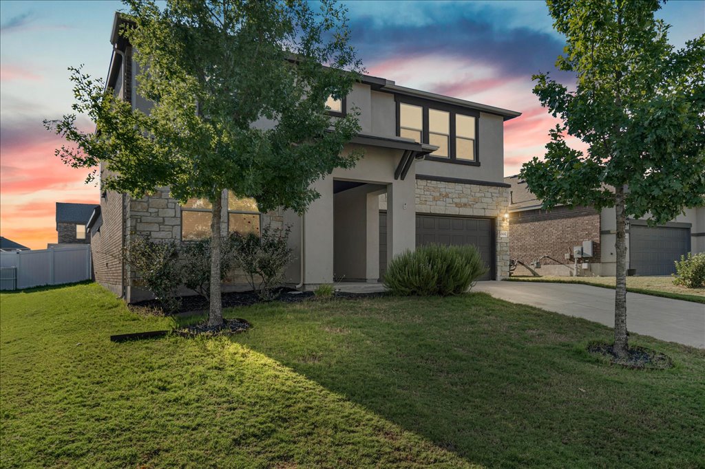 10909 Mickelson Drive Austin, TX 78747 - Photo 1 of 23 a front view of a house with a garden