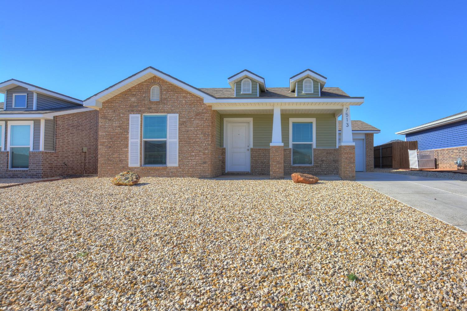 7513 28th Street Lubbock, TX 79407 - Photo 1 of 18 a front view of a house with a yard