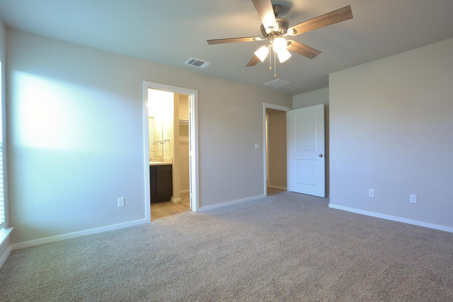 7513 28th Street Lubbock, TX 79407 - Photo 12 of 18 a view of an empty room with a ceiling fan