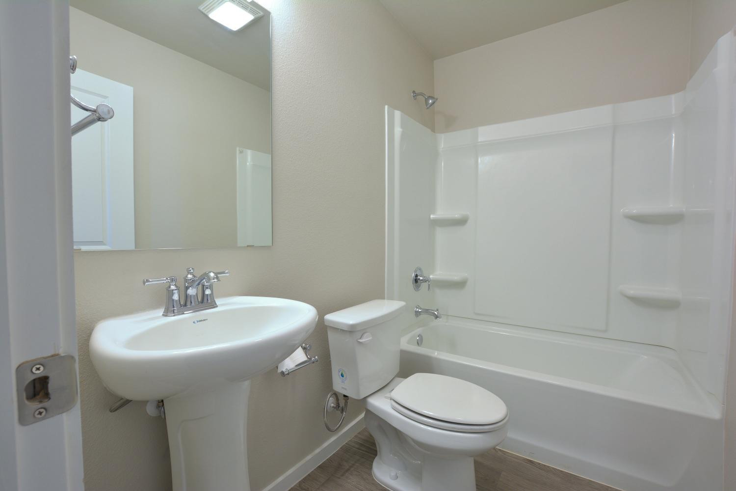 7513 28th Street Lubbock, TX 79407 - Photo 17 of 18 a bathroom with a sink toilet and shower