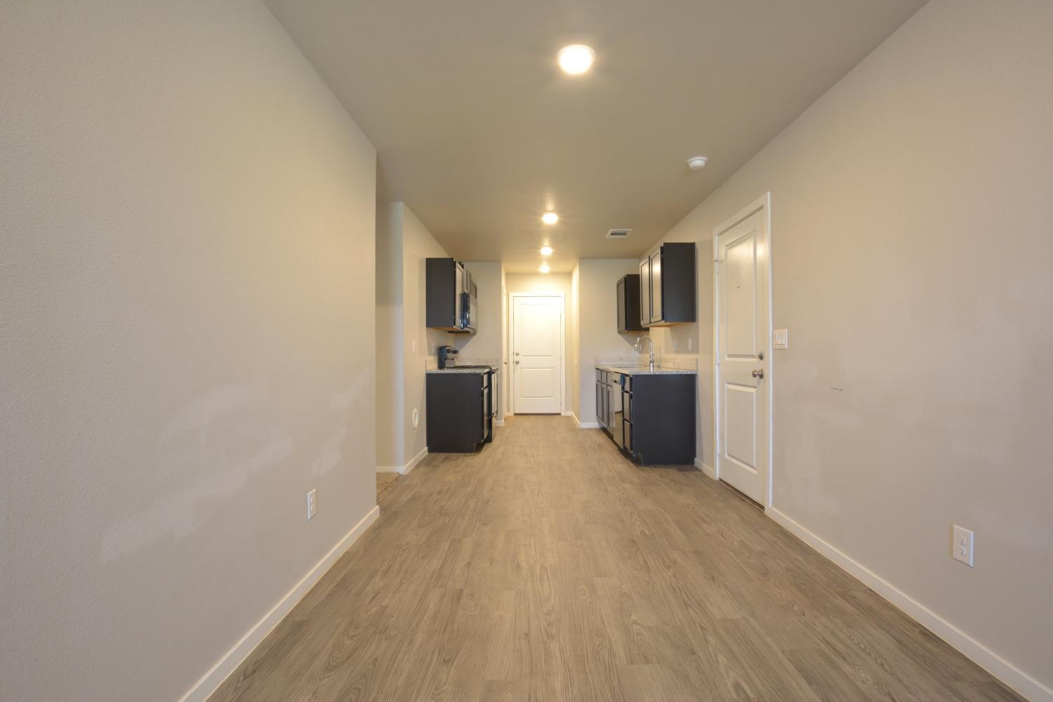 7513 28th Street Lubbock, TX 79407 - Photo 7 of 18 a view of a kitchen with a sink and an empty room