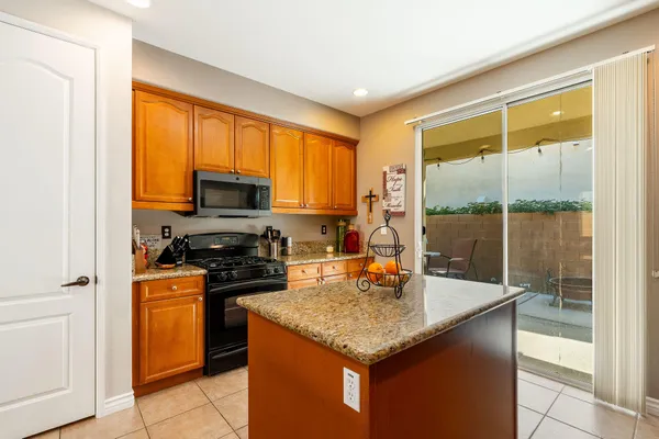 a kitchen with a stove a sink and a refrigerator