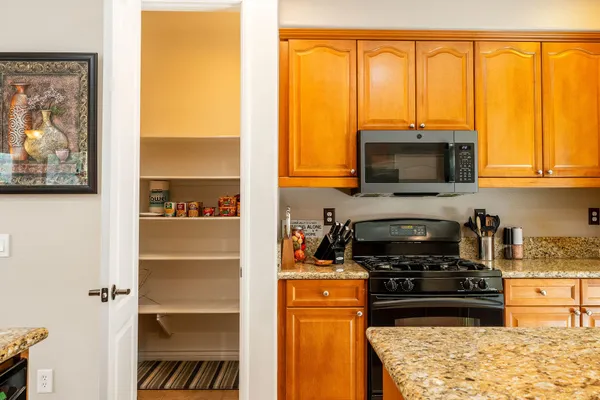 a kitchen with a window a sink and a microwave