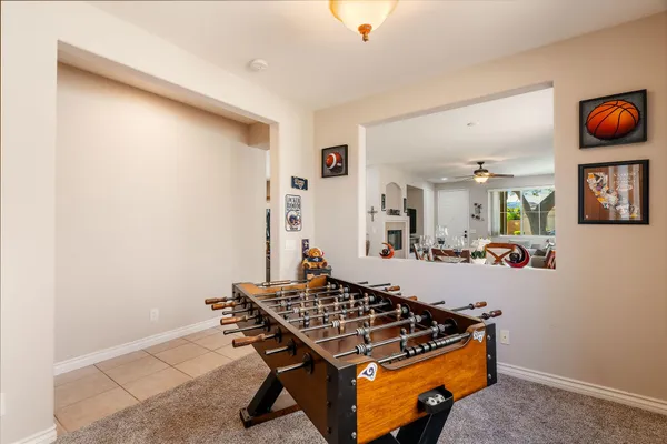 a living room with chairs and rug