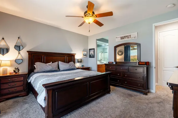 a bedroom with a bed and a chandelier