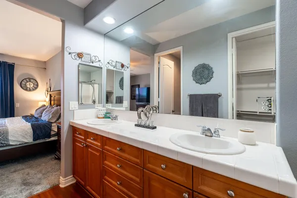 a bathroom with a double vanity sink and a mirror