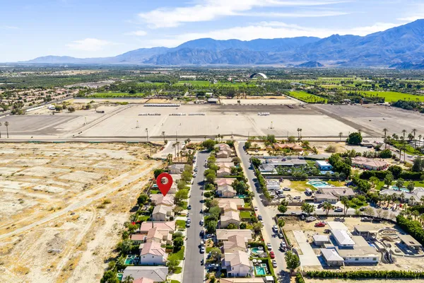 an aerial view of residential houses with outdoor space and trees