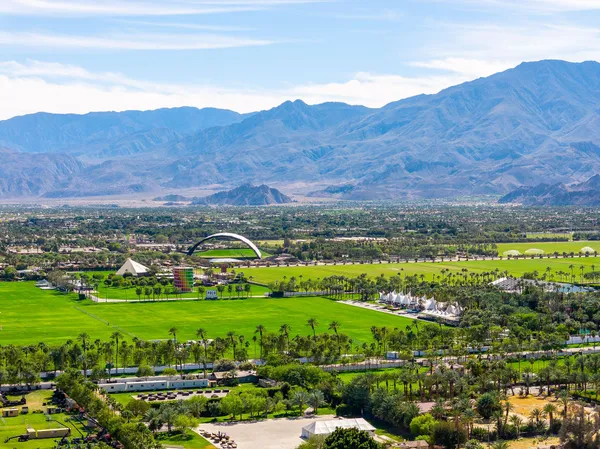 a view of a lush green hillside and houses