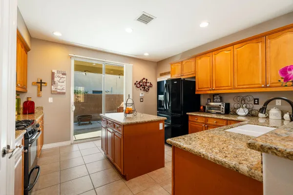 a kitchen with stainless steel appliances granite countertop a refrigerator and a sink
