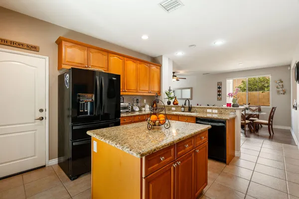 a kitchen with a sink a counter top space and stainless steel appliances