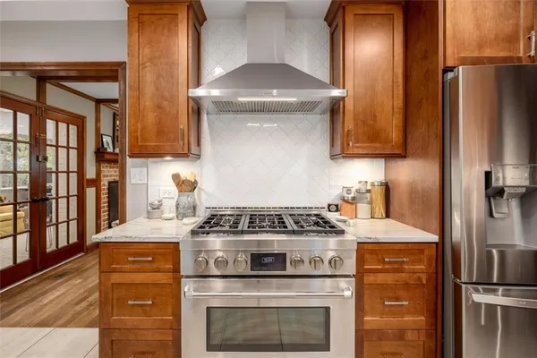a kitchen with a stove and a refrigerator