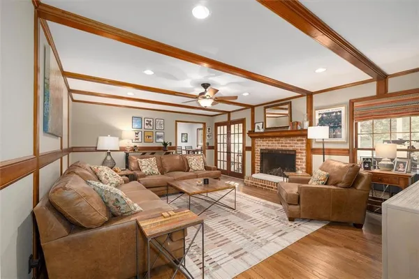 a living room with furniture a fireplace and a large window