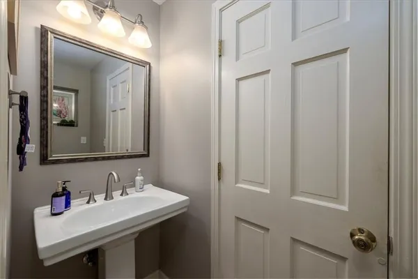 a bathroom with a sink vanity and a mirror