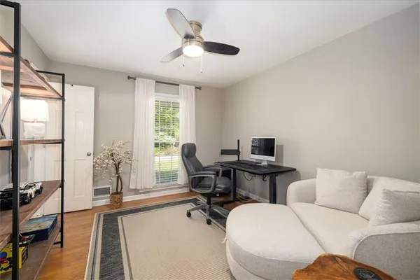 a living room with furniture a flat screen tv and a large window