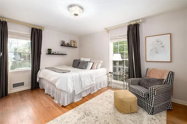 a bedroom with bed and a large window