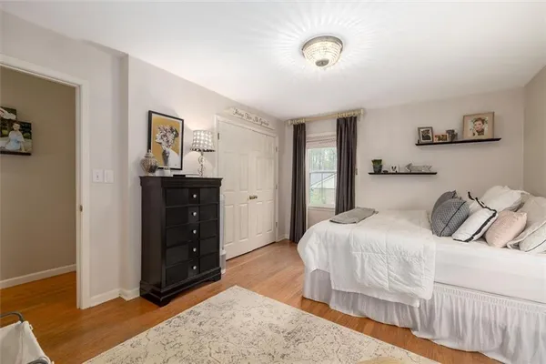 a bedroom with a bed and a dresser