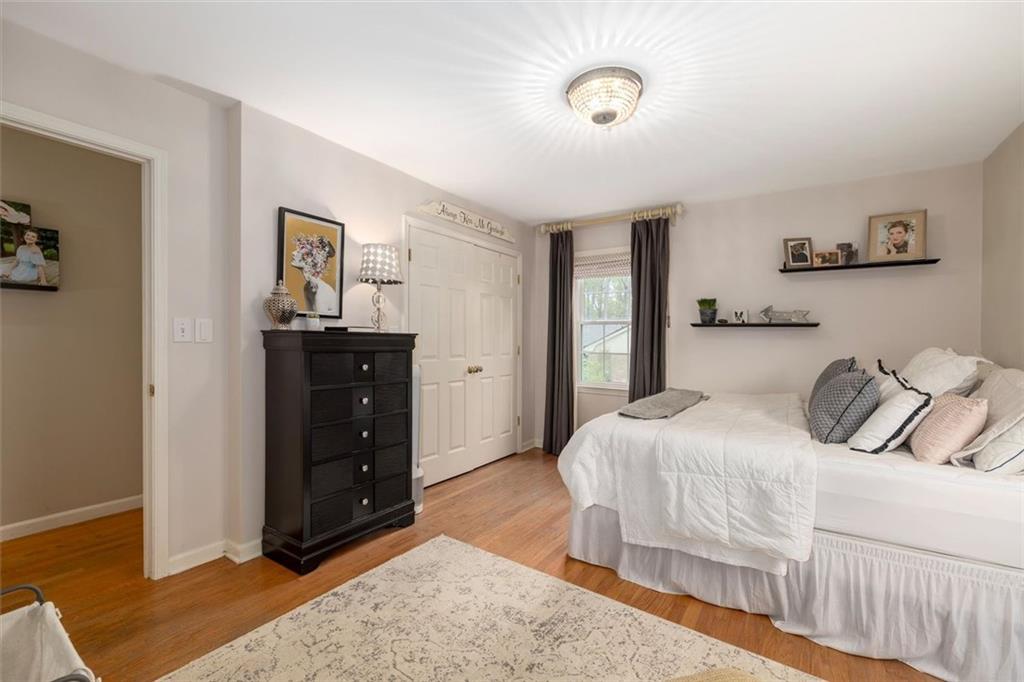 2282 Marthasville Court Smoke Rise, GA 30087 - Photo 25 of 48 a bedroom with a bed and a dresser