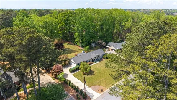 an aerial view of a house with a yard